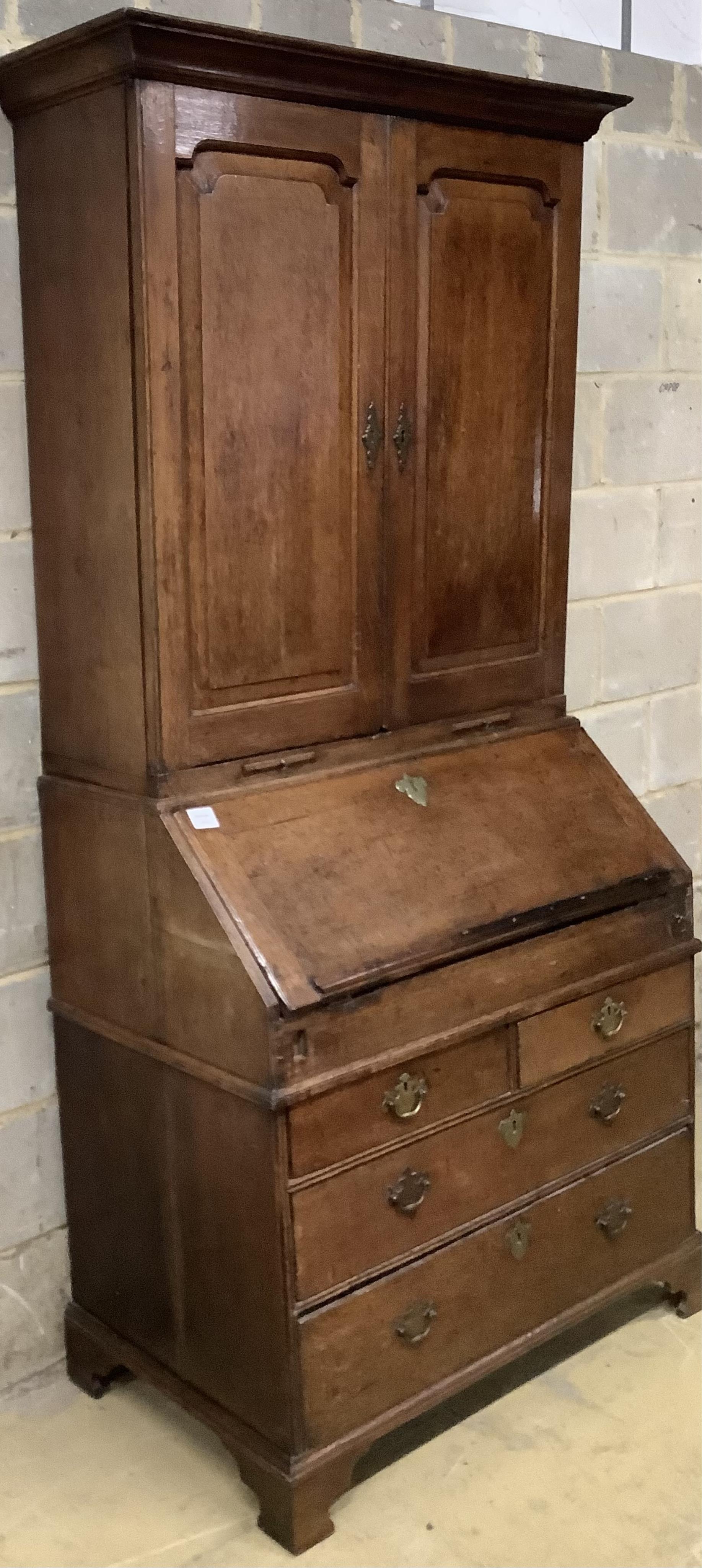 An early 18th century oak bureau cabinet, width 92cm, depth 54cm, height 199cm. Condition - fair